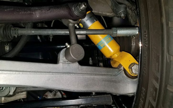 An image of a car part next to the car tire